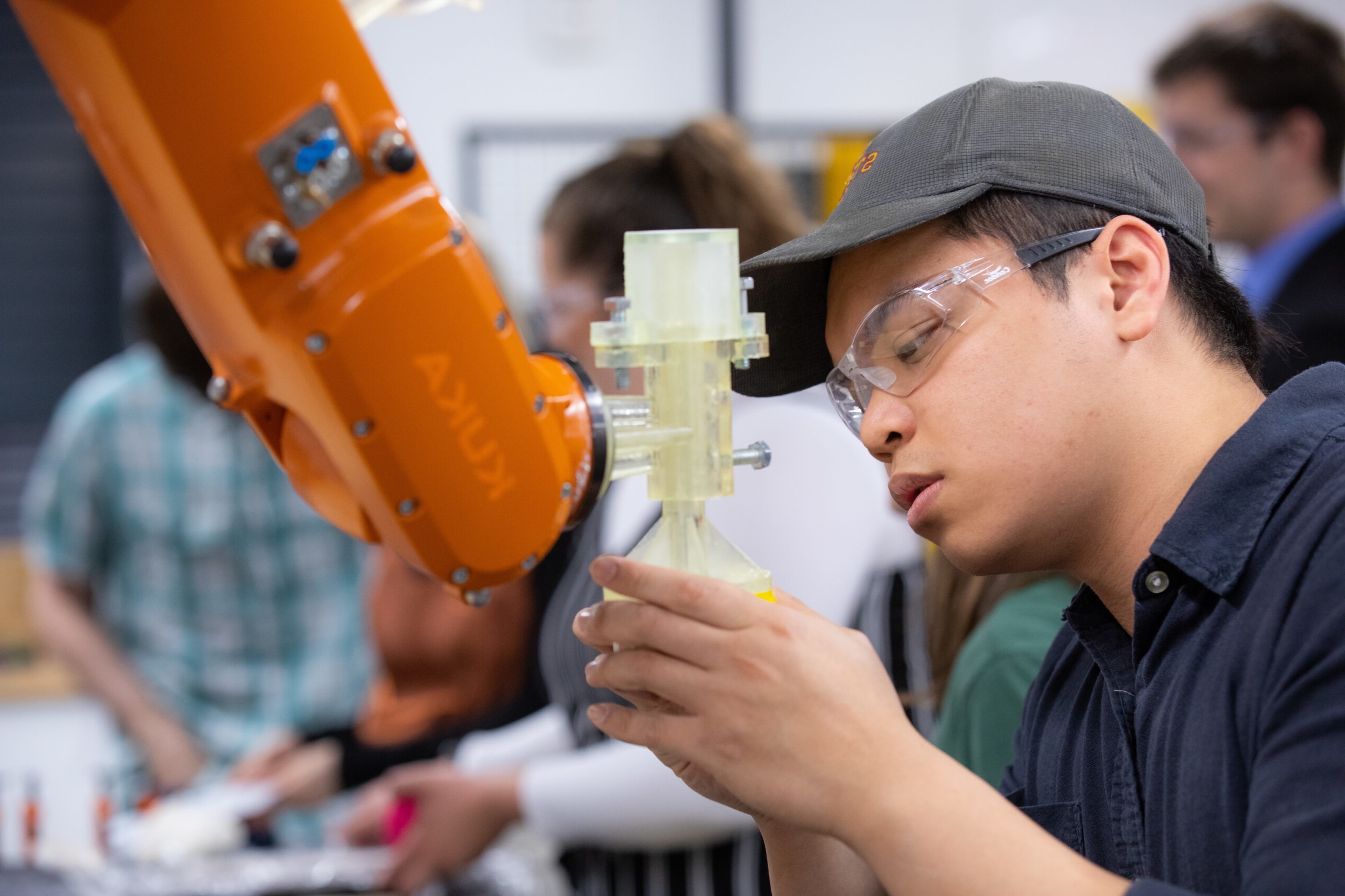man working on robot arm