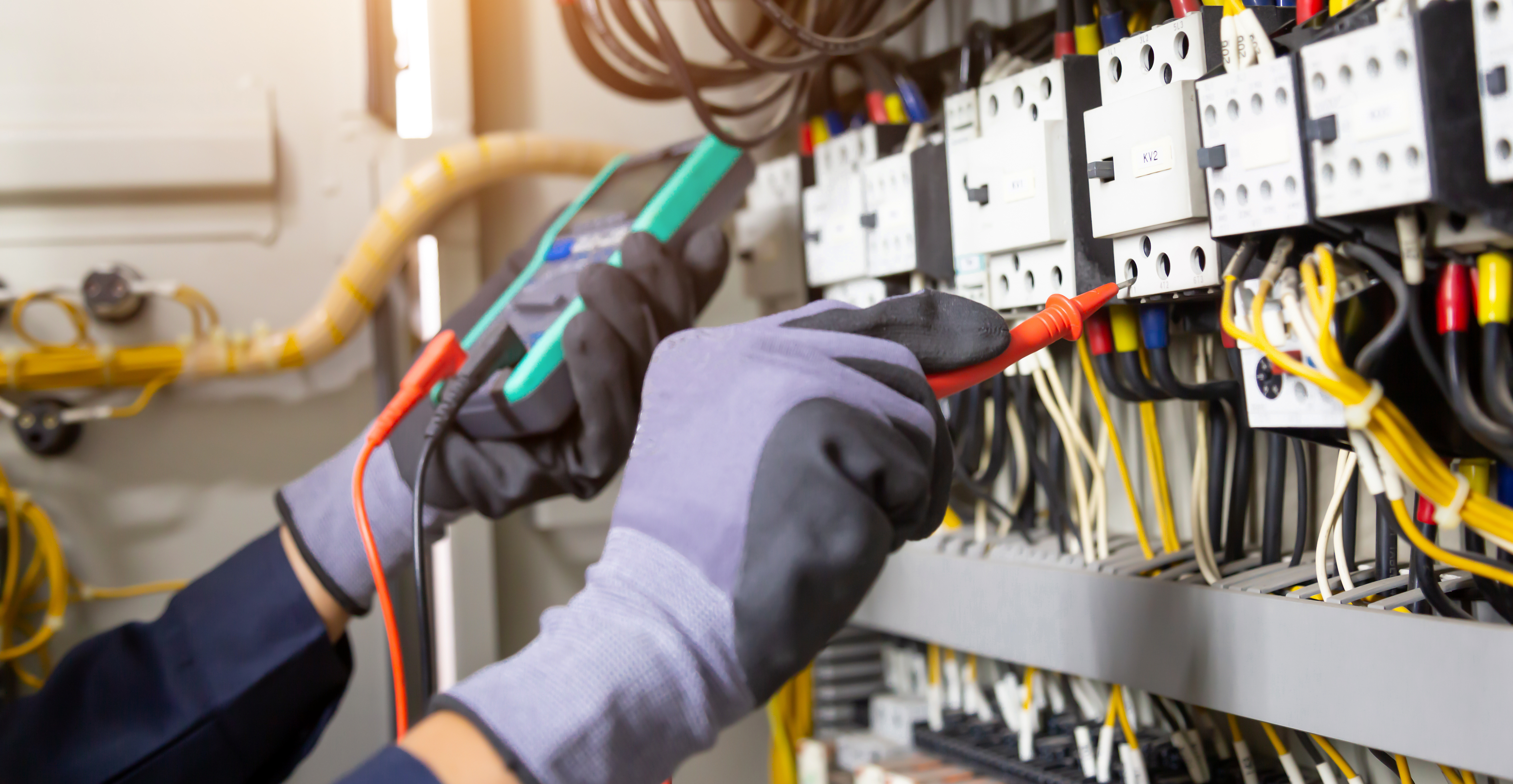 Electrician engineer tests electrical installations and wires on relay protection system