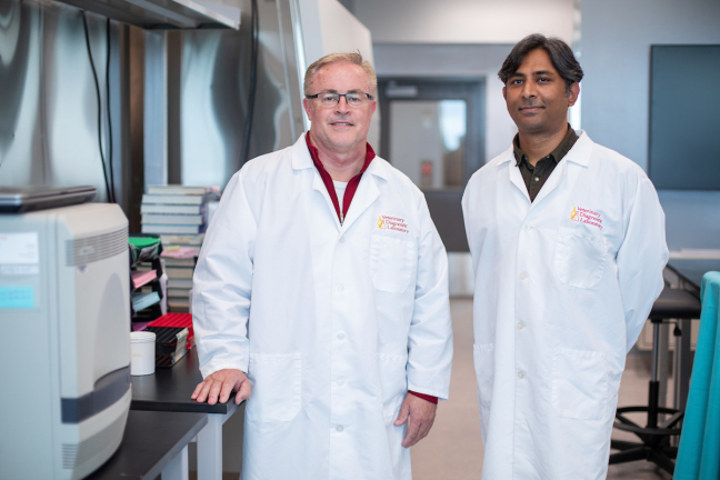 Phillip Gauger, left, and Rahul Nelli in a laboratory in the Veterinary Diagnostic Laboratory. Photo by Christopher Gannon/Iowa State University.