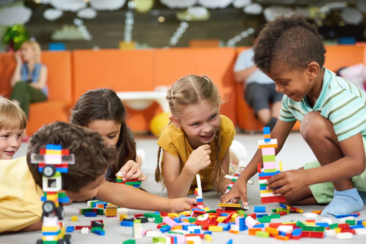 Cute kids playing together indoor. Preschool early education.